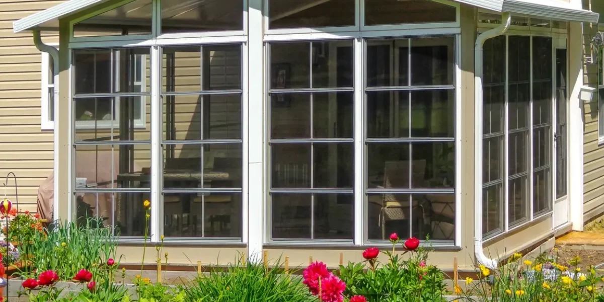 vinyl sunroom overlooking a garden with full fiberglass mesh screens to keep biting flies and mosquitoes outside